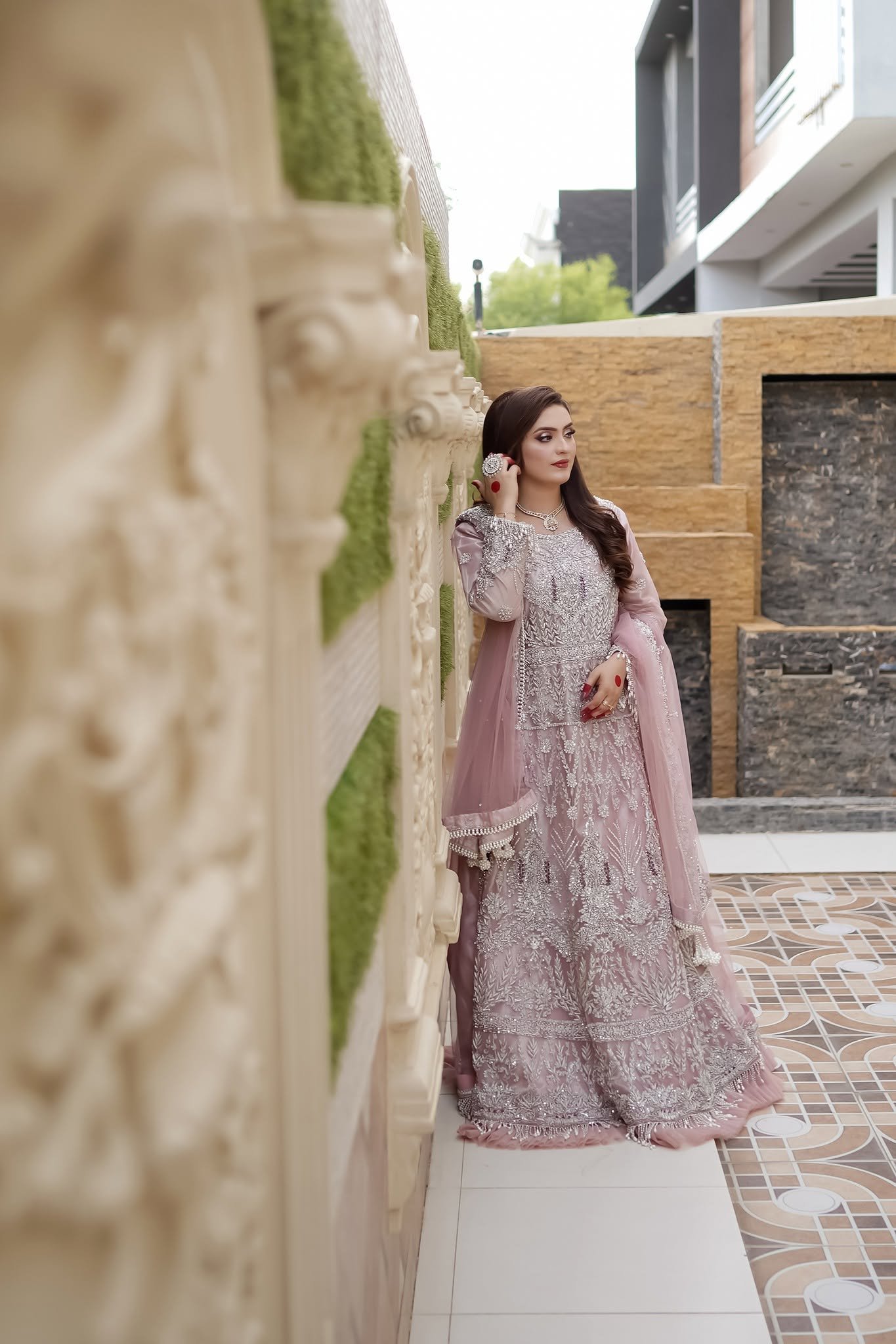 Party wear dress on rent in Bahawalpur — woman in pale pink lilac embroidered gown with pink dupatta outdoors